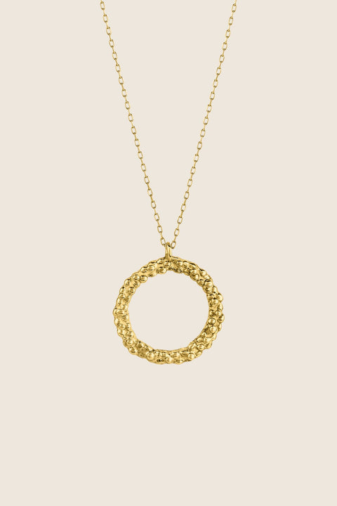 A circular pendant symbolizing perfection, crafted with a granulated, speckled silver texture inspired by the full moon. Suspended on a 50 cm silver chain, it works beautifully as a daily talisman or an elegant evening accessory. Discover cosmic elegance and timeless design by UMIAR jewelry.