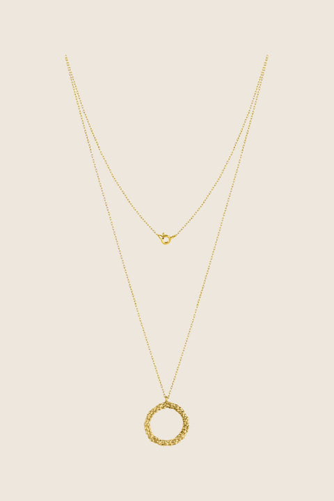 A circular pendant symbolizing perfection, crafted with a granulated, speckled silver texture inspired by the full moon. Suspended on a 50 cm silver chain, it works beautifully as a daily talisman or an elegant evening accessory. Discover cosmic elegance and timeless design by UMIAR jewelry.