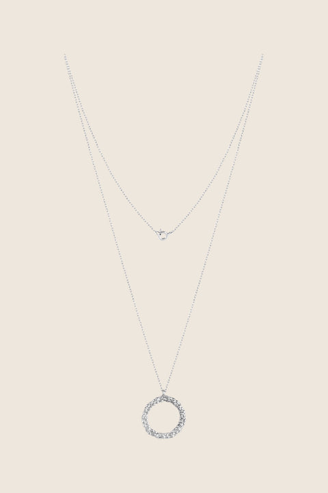 A circular pendant symbolizing perfection, crafted with a granulated, speckled silver texture inspired by the full moon. Suspended on a 50 cm silver chain, it works beautifully as a daily talisman or an elegant evening accessory. Discover cosmic elegance and timeless design by UMIAR jewelry.