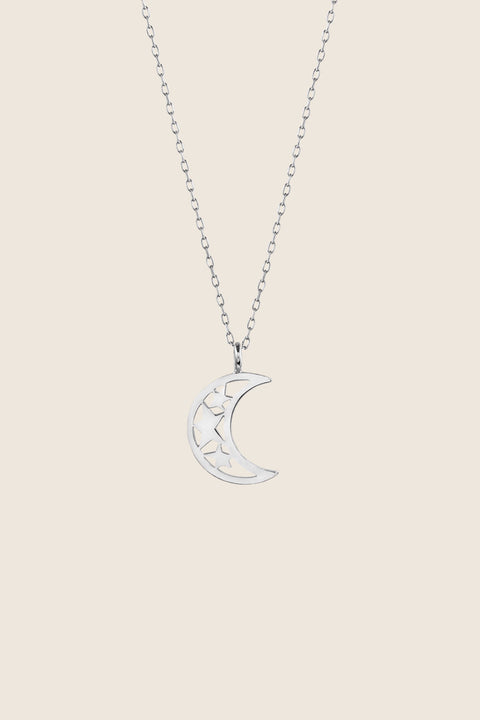 A minimalist moon-shaped pendant suspended on a 50 cm chain. With dimensions of 17 x 14 mm, this delicate necklace offers a subtle celestial accent suitable for everyday wear or elegant layering. Discover timeless symbolism and refined simplicity by UMIAR jewelry.