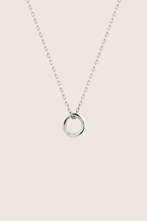 A minimalist necklace featuring a small circular pendant symbolizing balance and harmony. With a 10 mm pendant suspended on a 40 cm silver chain, it offers a delicate, understated accent ideal for everyday wear. A timeless talisman designed to complement any look. Discover refined simplicity by UMIAR jewelry.