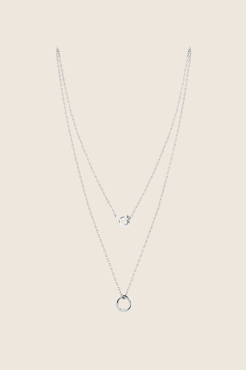 A minimalist necklace featuring a small circular pendant symbolizing balance and harmony. With a 10 mm pendant suspended on a 40 cm silver chain, it offers a delicate, understated accent ideal for everyday wear. A timeless talisman designed to complement any look. Discover refined simplicity by UMIAR jewelry.