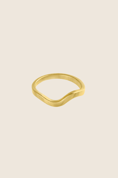 An elegant band ring with a fluid shape that shifts from a straight form into a gentle wave, symbolizing life and emotional flow. A UMIAR bestseller, it blends classic minimalism with subtle movement—perfect as a modern wedding band or an everyday essential. Discover timeless design with meaning by UMIAR jewelry.