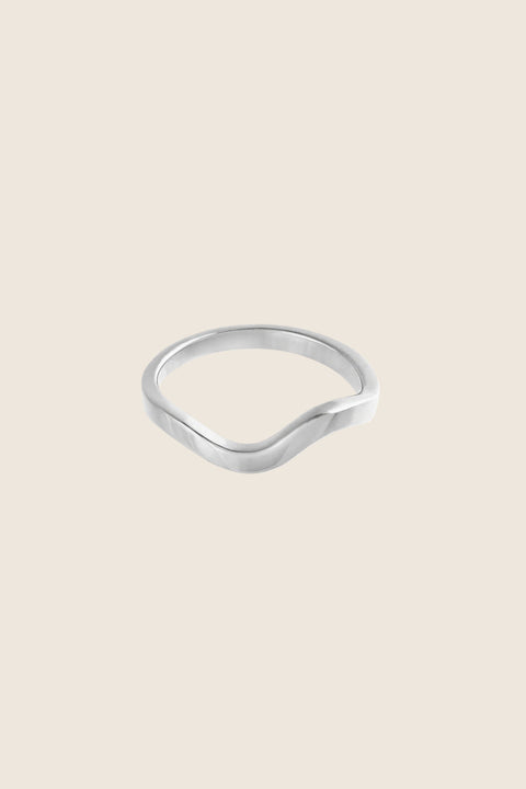 An elegant band ring with a fluid shape that shifts from a straight form into a gentle wave, symbolizing life and emotional flow. A UMIAR bestseller, it blends classic minimalism with subtle movement—perfect as a modern wedding band or an everyday essential. Discover timeless design with meaning by UMIAR jewelry.
