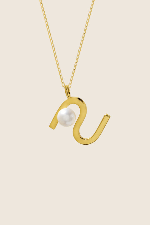An elegant necklace from UMIAR Jewellery featuring a unique wave-monogram form that gently frames a delicate natural pearl. Handcrafted in 925 sterling silver and 24k gold-plated 925 silver, it radiates refined style and meticulous craftsmanship. Every element of this design blends inspiration with artisanal precision, creating a distinctive piece that complements any look.