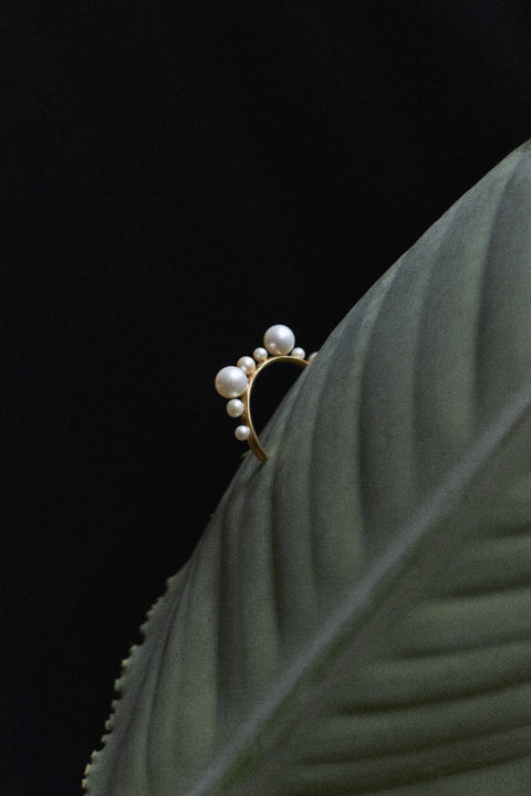 Discover the elegant and expressive hoop earrings adorned with natural pearls of varying sizes by UMIAR Jewellery. Their unique design makes them not only a beautiful accessory but also a bold statement piece in your look. Wear them on their own or paired with GEMINA inserts. Handcrafted from noble materials — 925 sterling silver and 24k gold-plated sterling silver. Find your unique style today!