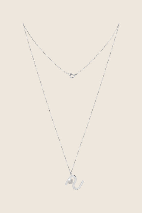 An elegant necklace from UMIAR Jewellery featuring a unique wave-monogram form that gently frames a delicate natural pearl. Handcrafted in 925 sterling silver and 24k gold-plated 925 silver, it radiates refined style and meticulous craftsmanship. Every element of this design blends inspiration with artisanal precision, creating a distinctive piece that complements any look.