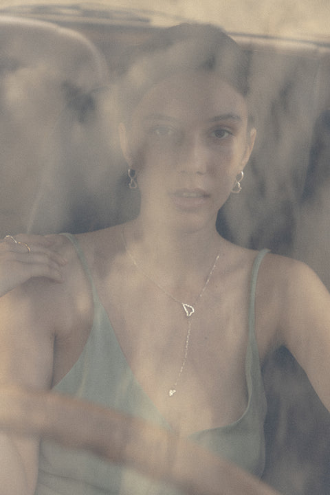 Discover a distinctive necklace from UMIAR jewellery that takes you on a journey to sun-drenched Capri. Handcrafted from 925 sterling silver and 24-carat gold-plated silver, this unique piece features two pendants inspired by the island’s topography and three chains that gracefully wrap around the neck, cascading down the neckline. The total length is 53 cm, with a 10 cm opposite chain. More than just an accessory — it’s a tribute to the beauty and spirit of Capri.