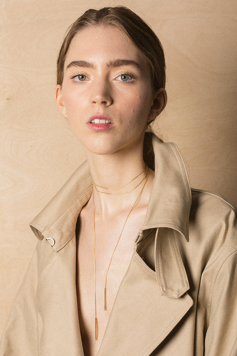 A handcrafted choker combining two 33 mm silver tube elements with a 120 cm chain. Designed for versatile styling, the chain can be tied, layered, or worn loose, including as a back neckline accent. Elegant silver ends ensure a perfect drape and refined finish. Discover modern, adaptable jewelry by UMIAR jewelry.