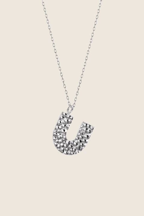 Add a touch of elegance to your collection with UMIAR jewelry. This U-shaped necklace with a hammered finish is handcrafted from 925 sterling silver or 925 sterling silver plated with 24-karat gold. Part of the WIĘZI Collection, it draws on traditional craftsmanship and open-work detailing. A unisex design created to celebrate meaningful connections.
