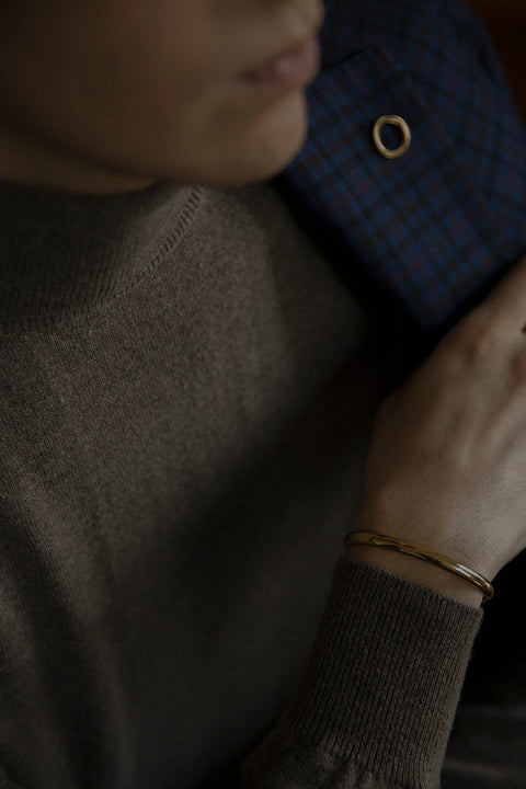 A minimalist bracelet crafted from a rigid silver tube with a distinctive semi-circular cross-section. Clean, elegant, and architectural, it offers a refined statement that complements both everyday and elevated styling. Discover timeless simplicity and modern form by UMIAR jewelry.