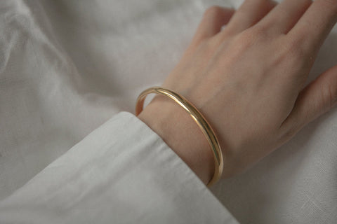 A minimalist bracelet crafted from a rigid silver tube with a distinctive semi-circular cross-section. Clean, elegant, and architectural, it offers a refined statement that complements both everyday and elevated styling. Discover timeless simplicity and modern form by UMIAR jewelry.