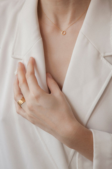 A minimalist necklace featuring a small circular pendant symbolizing balance and harmony. With a 10 mm pendant suspended on a 40 cm silver chain, it offers a delicate, understated accent ideal for everyday wear. A timeless talisman designed to complement any look. Discover refined simplicity by UMIAR jewelry.