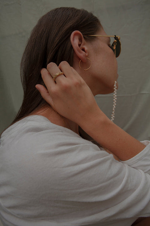 A textured band ring inspired by the sculptural surface of the moon, featuring a granulated, speckled silver finish. Elegant yet subtle, it complements both organic and minimalist jewelry styles. A distinctive everyday piece with a refined edge. Discover lunar-inspired design by UMIAR jewelry.