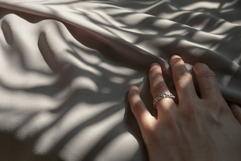 A textured band ring inspired by the sculptural surface of the moon, featuring a granulated, speckled silver finish. Elegant yet subtle, it complements both organic and minimalist jewelry styles. A distinctive everyday piece with a refined edge. Discover lunar-inspired design by UMIAR jewelry.